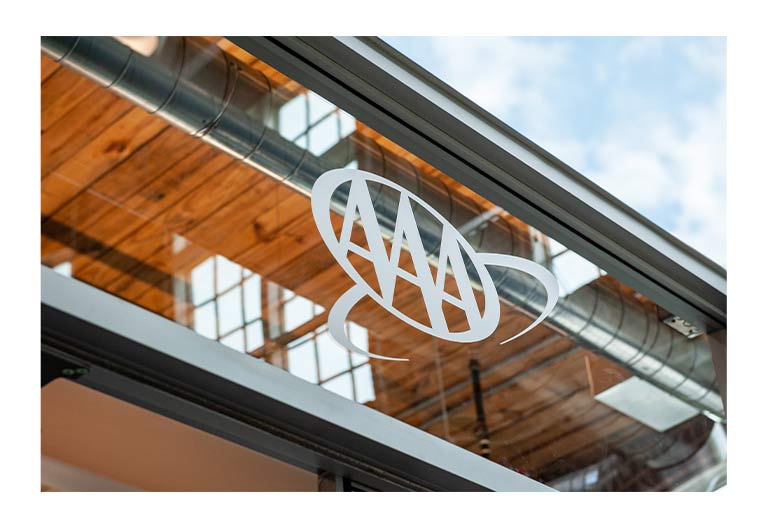 Glass building with the AAA logo.