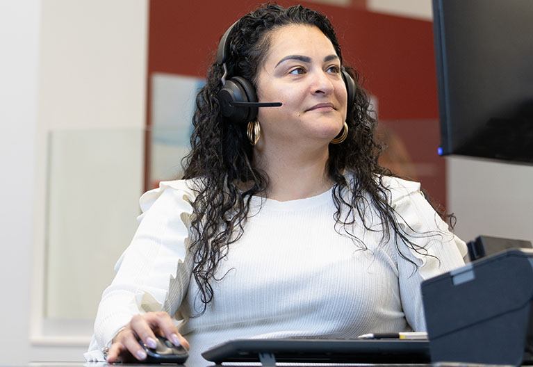 AAA employee answering phone calls at their desk.