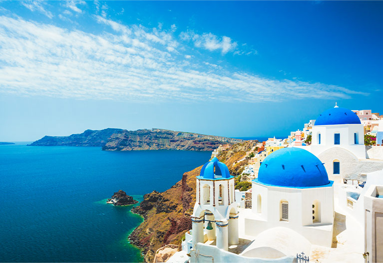 white church with blue turrets located in greece