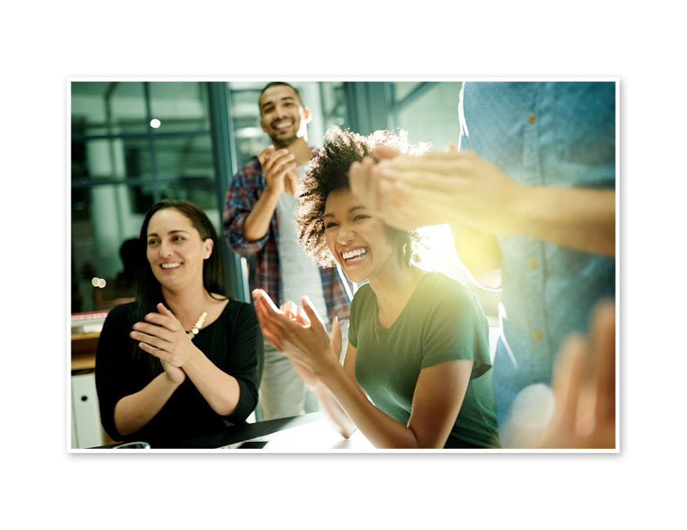 3 people smiling and applauding.