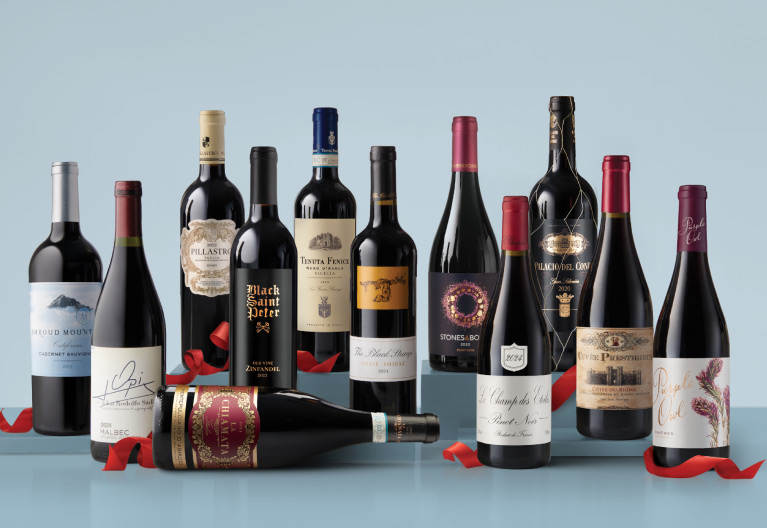 A selection of 12 wines displayed together with red holiday ribbon. 
