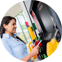 Woman smiling at gas pump.