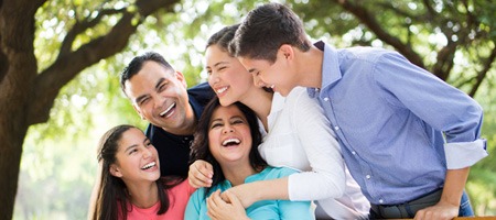 A family hugging and laughing.