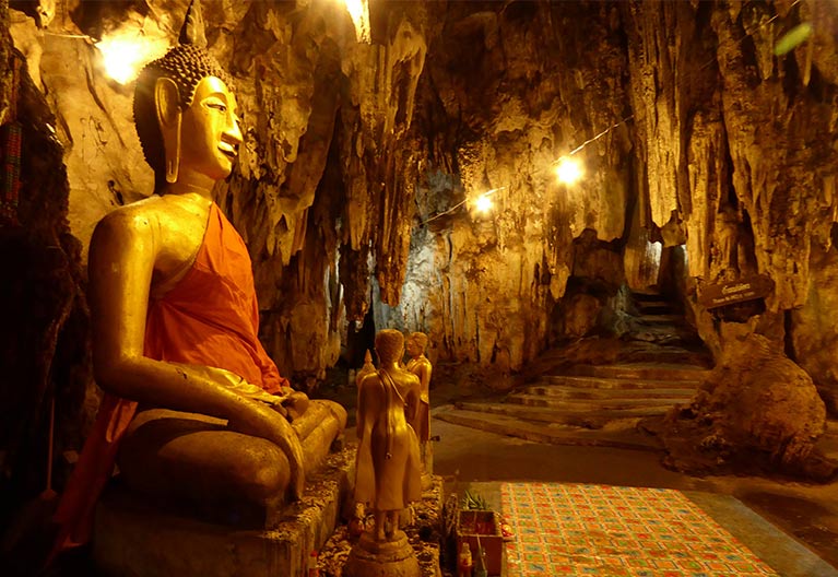 A buddha statue in a cave.