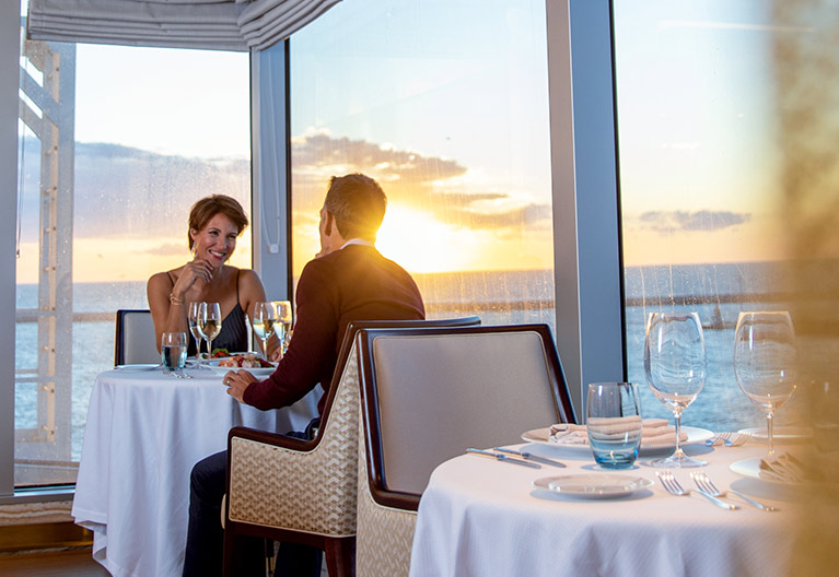 A couple dining on a cruise ship.