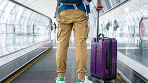 person standing with luggage