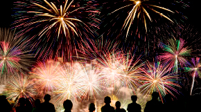 Fireworks with silhouettes of people watching 