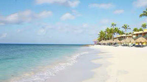 Cabanas along the shore of a beach resort.
