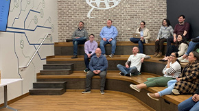A group of AAA employees in a meeting area