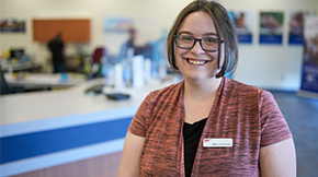 AAA branch employee standing in front of the counter.