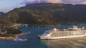 Cruise ship docked at a tropical island.