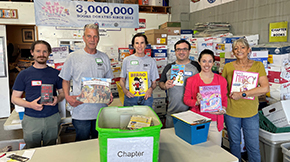 A group of AAA Northeast employees holding up their donations.