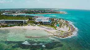 An aerial view of the Hilton Tulum Resort from above the water.