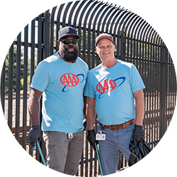 Two AAA employees taking a photo together at a cleanup volunteer event.