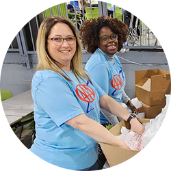 Group of AAA employees packing boxes at a volunteer event.