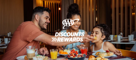 AAA Discounts & Rewards text over an image of a family eating