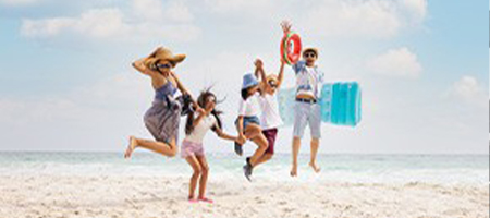 Family jumping together on a Florida beach.