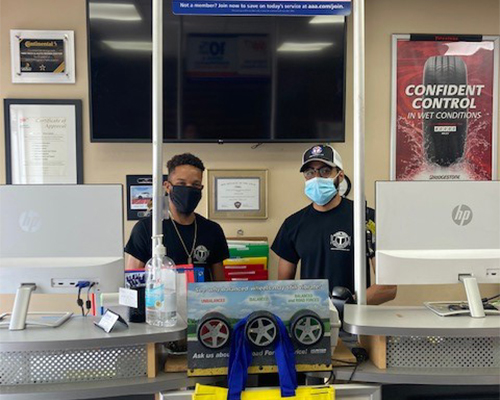 Tire Tech employees at store computers.